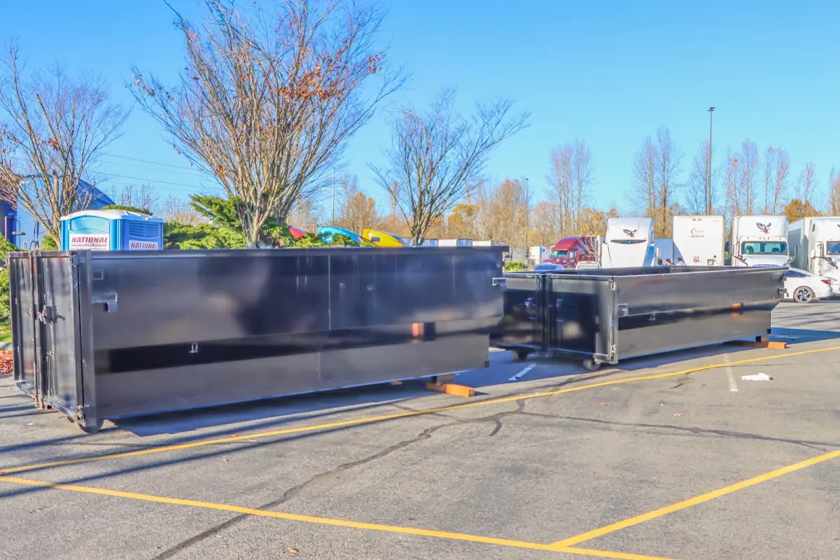 Professional dumpster rental service with roll-off container on residential driveway in Globe
